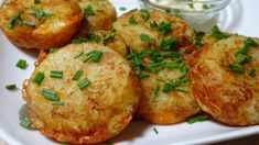 some food is on a white plate with green garnishes and mayonnaise