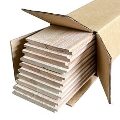 a stack of unfinished wooden boards in a cardboard box on a white background with clippings