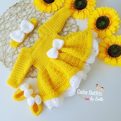 a crocheted yellow dress and booties with sunflowers