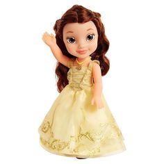 the doll is wearing a yellow dress with gold trimmings and has brown hair