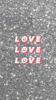 the word love is written in red and white on a gray background with small stars