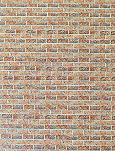 an orange and brown brick wall textured with small squares