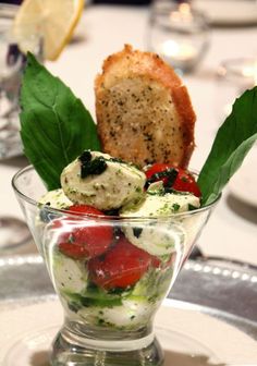 a glass bowl filled with food on top of a table