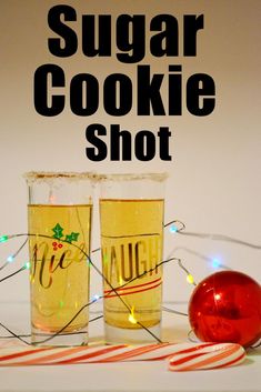 two shot glasses with candy canes next to them and the words sugar cookie shot