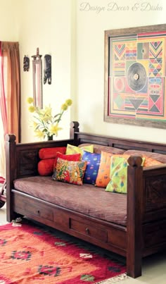 a living room with a couch, rug and painting hanging on the wall above it