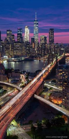 an aerial view of a city at night with the lights on and traffic going by