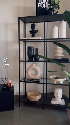 a shelf filled with lots of different types of vases and other decorative items on top of it