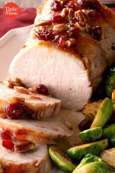 pork with cranberry sauce and brussel sprouts on a plate