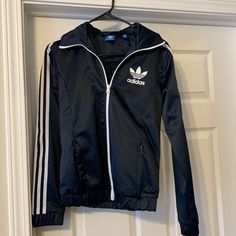 Nwot Adidas Shiny Navy, Has A Sheen That Feels So Nice White Stripes Down Sleeves Elasticized Waist Band Full Zip 2 Zipped Pockets In Front Size Small Adidas Long Sleeve Windbreaker For Fall, Casual Adidas Navy Track Jacket, Adidas Navy Casual Track Jacket, Casual Navy Adidas Track Jacket, Navy Long Sleeve Windbreaker, Adidas Navy Long Sleeve Track Jacket, Navy Adidas Long Sleeve Track Jacket, Navy Long Sleeve Track Jacket For Spring, Adidas Fitted Hooded Outerwear