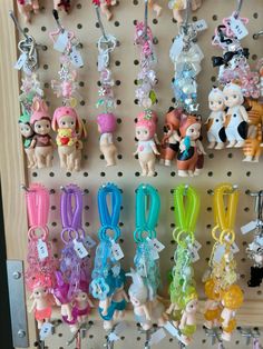 there are many key chains hanging on the pegboard in this room, and they have little charms attached to them