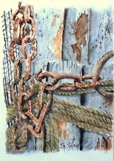 an old rusty chain is attached to a wooden fence with rusted paint on it