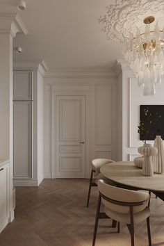 an elegant dining room with white walls and wood flooring, chandelier hanging from the ceiling