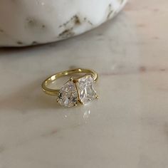 two stone ring sitting on top of a marble table