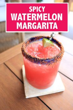 a red drink sitting on top of a wooden table