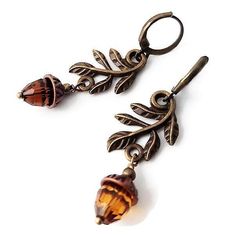 Nature-inspired in earthy colors, these adorable antique brass leaf and acorn earrings are the perfect addition to your Autumn jewelry collection. Light or dark brown exotic bridesmaid accessory with a little sparkle for a barn or garden Fall wedding. The acorn is a symbol of growth and unlimited potential. Whether you're looking for growth, perseverance, or stability, the acorn symbolizes it all. All the wonder in a mighty oak grows from a single acorn. Cute just out-of-the-forest acorn earring Dark Cottagecore Jewelry, Garden Fall Wedding, Nature Accessories, Forest Earrings, Acorn Jewelry, Acorn Earrings, Autumn Accessories, Autumn Earrings, Autumn Jewelry