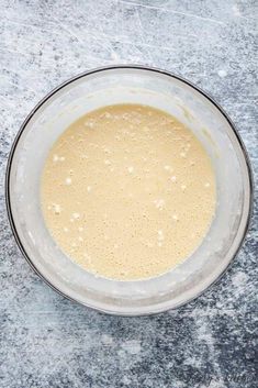 a bowl filled with batter on top of a table