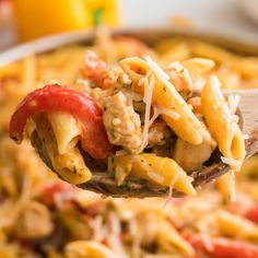 a spoon full of pasta with chicken and tomatoes