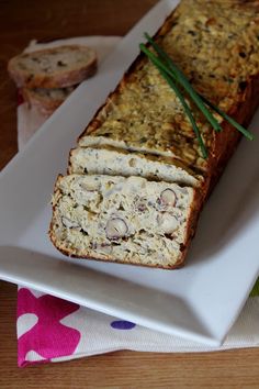 a white plate topped with a loaf of bread