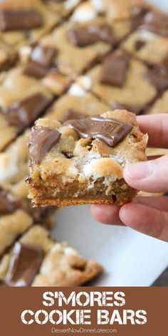 someone holding up a cookie bar with chocolate chips