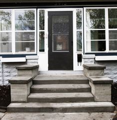 the front door of a house with steps leading up to it