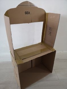 an open cardboard box sitting on top of a white floor