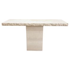 a white marble table with a square base on the top and one leg in the shape of a rectangle