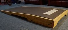 a wooden table sitting on top of a carpeted floor