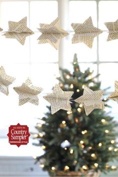 a christmas tree with paper stars hanging from it