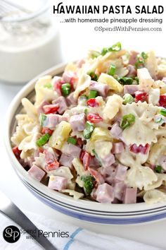 hawaiian pasta salad with homemade mayonnaise dressing in a white bowl on a blue and white striped plate