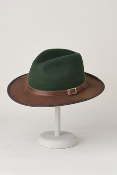 Bask in your own outback adventure with the Pinnacle, exquisitely created in bold two-tone and tone-on-tone styles. Whether you're exploring a dusty trail or strolling along a shimmering stream, this handmade, 100% wool hat will shade you with its wide, cowhide leather brim. Accented with a leather band and buckle, the Pinnacle is appointed with an interior drawstring sweatband to keep you cool and ensure a comfortable fit. Safari Hat, Handmade Hat, Wool Hat, Leather Band, Cowhide Leather, Wool Felt, Two Tone, Comfort Fit, Felt