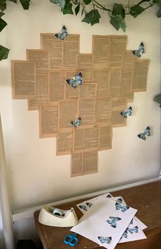 a bulletin board with butterflies on it next to some scissors and other things in front of it