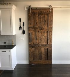 an open wooden door in a white kitchen