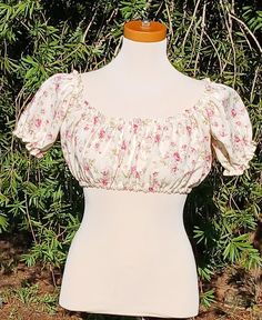 Embrace timeless charm with this handmade crop top, crafted from vintage Rose fabric.  This is a Crop Top, not a Midriff (longer). This Top measures 30-32 around the bust.  Each top is a one-of-a-kind piece, combining classic charm with modern style. Whether you're dressing up for a day out or adding a unique touch to your everyday look, this crop top is your perfect match. This top would pair perfectly with a pair of jeans & boots for a day at the farmers market.  This is truly One Of A Kind. I only found 2 yards of this fabric at an estate sale. Fitted Vintage Floral Print Crop Top, Fitted Vintage Crop Top For Summer, Fitted Cropped Tops For Garden Party, Vintage Cropped Floral Print Top, Vintage Floral Print Crop Top For Spring, Vintage Short Sleeve Crop Top For Spring, Vintage Short Sleeve Tops For Garden Party, Vintage Fitted Cropped Top, Fitted Cropped Vintage Crop Top