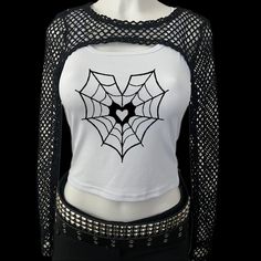 * Sublimated heart spiderweb emo goth cropped tank top * Mannequin is wearing size M * Mannequin measurements:    * Bust: 35" (C cup)    * Waist: 26"    * Hip: 40" * Soft, breathable, and stretchy material * For a looser fit, size up * Please note that all items are Made to Order & there may be slight variations in appearance Emo Black Top For Festival, Edgy Stretch Tank Top For Halloween, Y2k Black Top For Cosplay, Punk Style Black Tank Top For Halloween, Black Y2k Style Tops For Cosplay, Punk Stretch Tank Top For Halloween, Edgy Black Tank Top For Halloween, Edgy Black Crop Top For Halloween, Black Tank Top For Halloween Festival