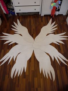 the floor is made out of paper and has white wings on it, as well as a pair of scissors