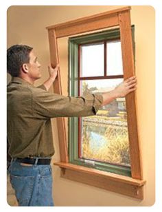 a man holding up a window to look out the window