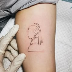 a woman's arm with a tattoo on it and a drawing of a girl