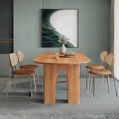 a dining table with four chairs and a painting on the wall in an empty room