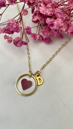 Dive into the realms of sentiment with our heart-shaped rose petal necklace--a poignant tribute designed to honor, love, and remember. Meticulously handcrafted, this necklace encapsulates the essence of enduring emotions, with delicate rose petals creating an exquisite visual tapestry within its golden contours. With an 18-inch chain gracefully draping the neckline and a considerate 2-inch extender for personalized wear, this necklace is not just an accessory but a vessel for cherished memories. The gold-plated finish adds a touch of opulence, amplifying the profound sentiments it holds. Resilient against life's elements, this water-resistant necklace ensures that the beauty of the rose petals remains unblemished--a lasting symbol of love. To make it even more personal, the option to inclu Heart Charm Necklace For Mom With Round Pendant, Heart Charm Necklace Gift For Mom, Charm Necklace With Heart Pendant For Mom, Heart Charm Round Pendant Necklace As Gift For Mom, Round Pendant Heart Charm Necklace As Gift For Mom, Gift Charm Necklace With Initial Pendant And Flower Charm, Initial Pendant Charm Necklace For Gift, Initial Pendant Charm Necklace As Gift, Heart Charm Initial Pendant Necklace Gift For Her