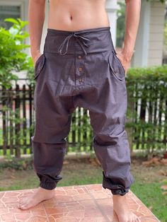 "Street Samurai Style Pants, Unique style Ninja pants are comfortable, Samurai Pants, Drop Crotch Pants are comfortable to wear. Handmade with a very lovely pattern, it is easy to wear and great for many occasions. Fashion Street Style Pants, Handmade Ethically, Breathable, Unisex, Comfortable to Wear MATERIAL: Cotton fabric SIZE: Size with Elastic waist and tied MEASUREMENT: Waist: 30\"- 40\" elastic & waist-tied Hip 46\" Waist to Gusset 19\" Inseam 28\" Ankle 10 -12\" Length: 41-43\" ❤ PAY Cotton Harem Yoga Pants With Pockets, Baggy Cotton Yoga Pants For Festival, Cotton Hippie Harem Pants For Meditation, Hippie Cotton Harem Pants For Meditation, Hippie Cotton Bottoms For Meditation, Hippie Cotton Harem Yoga Pants, Bohemian Cotton Parachute Pants For Yoga, Bohemian Cargo Pants With Pockets For Festival, Bohemian Cargo Pants For Festivals