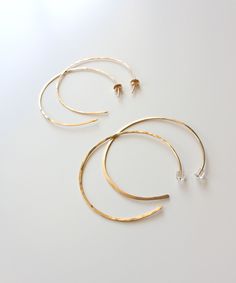 "Our Maya Open Hoop earrings are weightless and versatile for your daily style. Handcrafted from 14k Gold Filled wire, the hammered texture reflects light from all sides. Easy open hoop design adds a modern update to your everyday hoop. Choose from 1.75\" or 2\" sizing and either Thin 20 gauge style with gold earring backs, or Thicker 18 gauge style with clear earring backs. Please note the 18 gauge option is thicker than typical ear wire, so if you have sensitive ears, you may want to choose th Hoop Earrings Large, Boho Hoop Earrings, Clear Earrings, Hammered Hoop Earrings, Open Hoop Earrings, Gold Filled Hoops, Hammered Gold, Gold Filled Earrings, Beaded Hoop Earrings