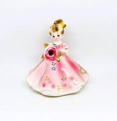 "Josef Originals Girl figurine, A charming girl holds a Rose flower with Garnet rhinestone center. She wears a pretty pink dress with embossed flowers & gold details. Perfect for a gift or collect for yourself! January Lady. Measures: 4.25\" tall x 4\" wide. Condition: Very good vintage condition. No chips or cracks. Signed on bottom. Original January sticker on dress. Please visit our shop to view our entire vintage selection at DartmouthHill: https://www.etsy.com/shop/DartmouthHill?ref=hdr_sho Pretty Pink Dress, Pink Vanity, Josef Originals, Butterfly And Flower, Rabbit Decor, Porcelain Roses, Bunny Decor, Lipstick Holder, Vintage Jewelry Box