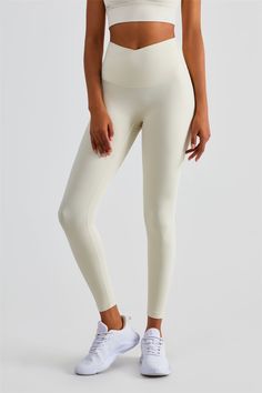 Why We Love It: Venture into a realm of chic sophistication and unmatched performance with the Naomi Cross Over Seamless Snatched Waist Leggings. With design cues taken from modern elegance and a promise of an unparalleled fit, these leggings are for the fearless, the trendsetters, and those who aspire for perfection in every stride. Fit and Features: Unique cross-over waistband emphasizes a slim profile and offers core stability. Seamless construction promises a smooth, chafe-free experience. S White Micro-elastic Tights, Chic Seamless White Bottoms, Chic White Seamless Bottoms, White 4-way Stretch Leggings For Pilates, High Stretch Beige Leggings, Cream Stretch Yoga Activewear, Fitted Cream Activewear For Yoga, White High Stretch Seamless Leggings, High Stretch Seamless White Leggings