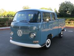 an old vw bus parked in a parking lot