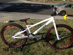 a white and red bike parked in the grass