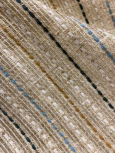 a close up view of the fabric with blue and brown stripes on it, as seen from above