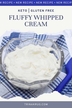 a glass bowl filled with whipped cream on top of a blue and white checkered cloth