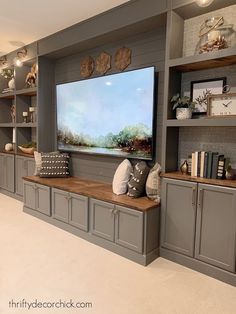 a large flat screen tv mounted to the side of a wall in a living room