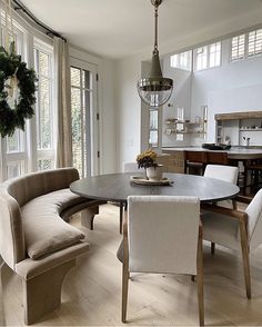 the dining room table is surrounded by beige chairs