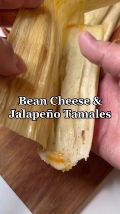 a person is holding an egg and cheese tamales in their hand with the words bean cheese & jalapeno tamales on it